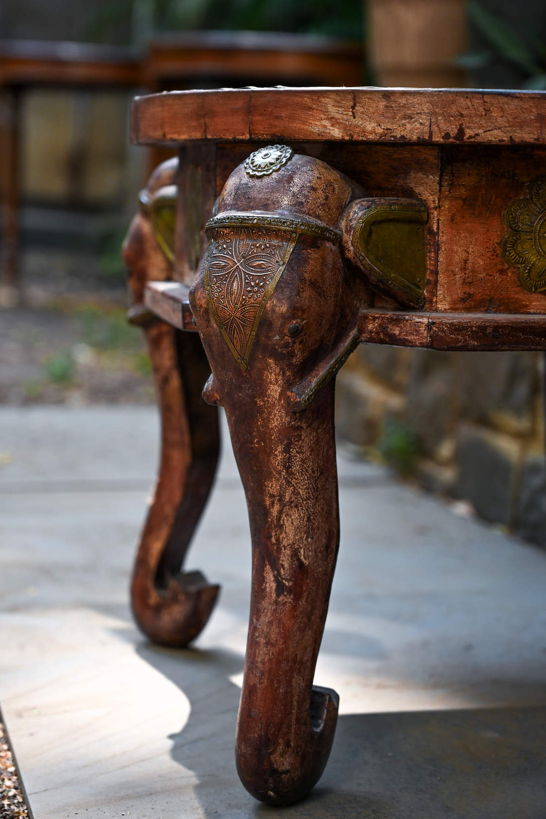 ELEPHANT MEDALLION - ROUND TEAK TABLE WITH BRASS REPOUSSÉ ELEPHANT FACES