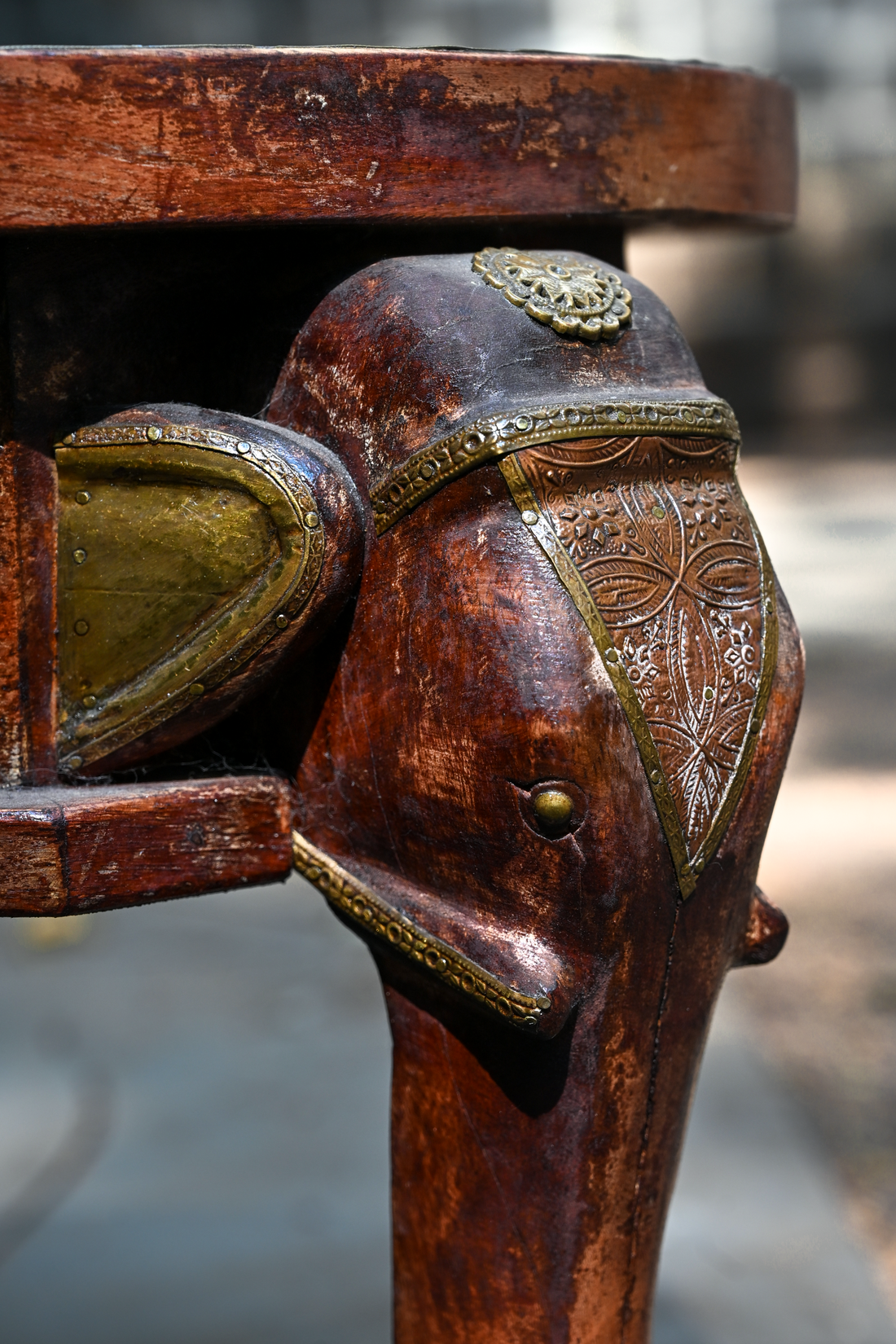 ELEPHANT MEDALLION - ROUND TEAK TABLE WITH BRASS REPOUSSÉ ELEPHANT FACES