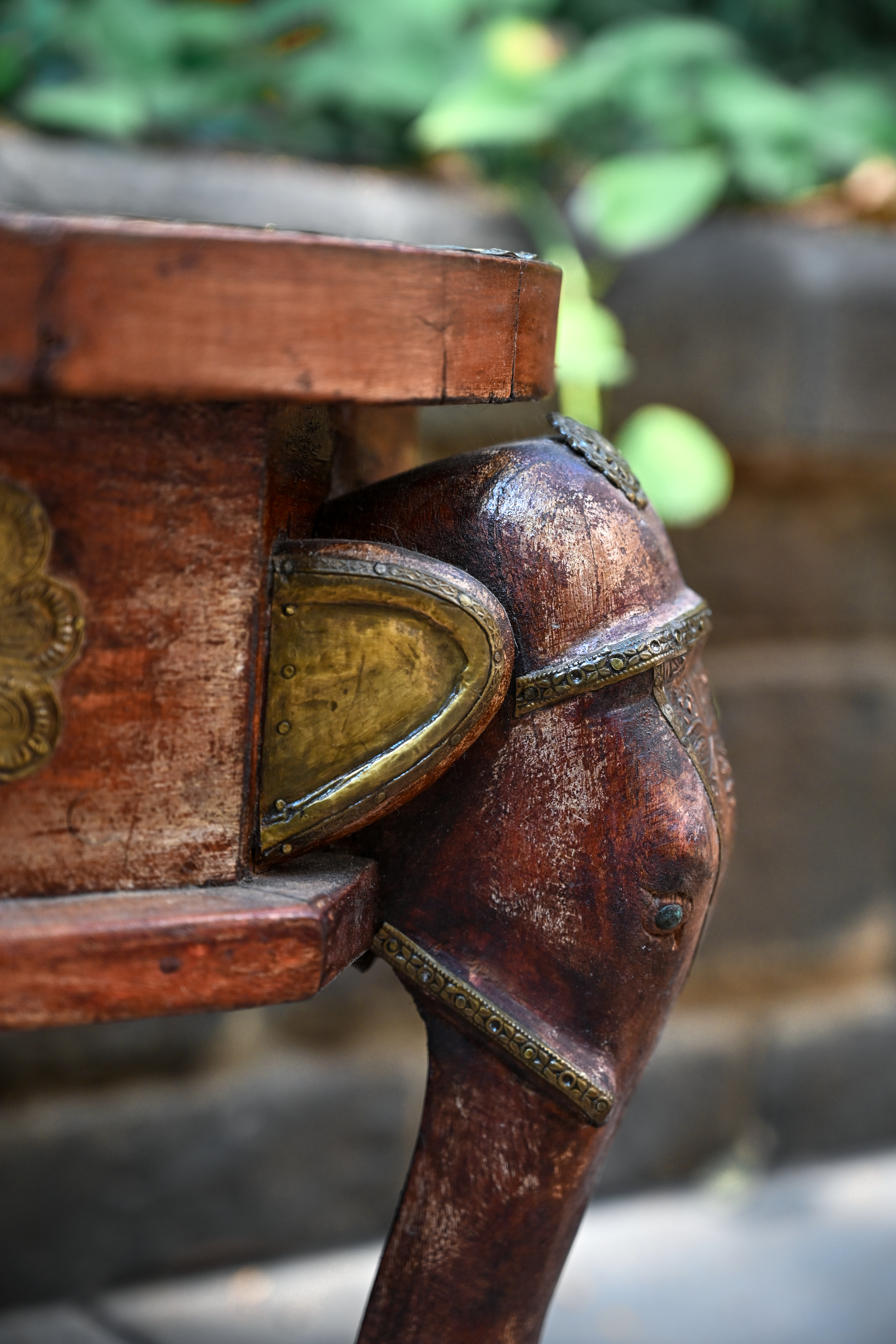 ELEPHANT MEDALLION - ROUND TEAK TABLE WITH BRASS REPOUSSÉ ELEPHANT FACES