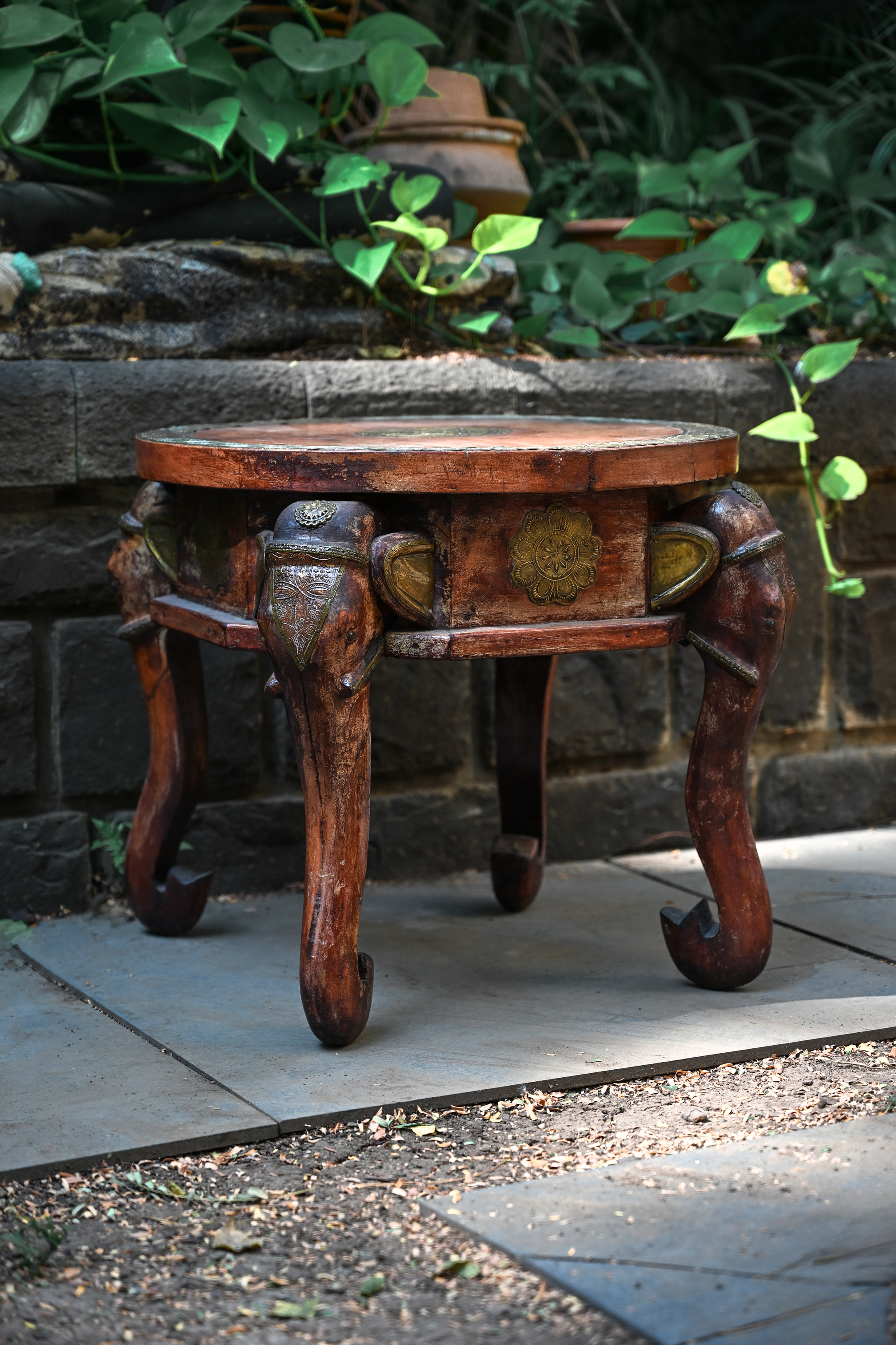 ELEPHANT MEDALLION - ROUND TEAK TABLE WITH BRASS REPOUSSÉ ELEPHANT FACES