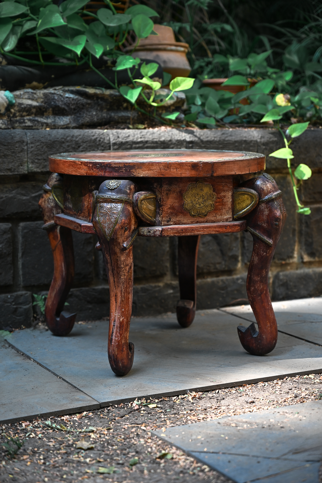ELEPHANT MEDALLION - ROUND TEAK TABLE WITH BRASS REPOUSSÉ ELEPHANT FACES