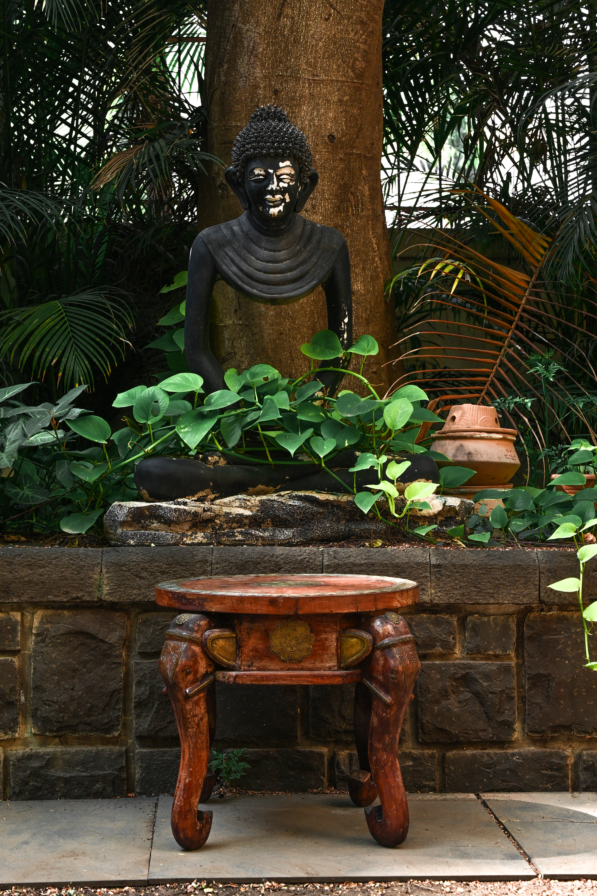 ELEPHANT MEDALLION - ROUND TEAK TABLE WITH BRASS REPOUSSÉ ELEPHANT FACES