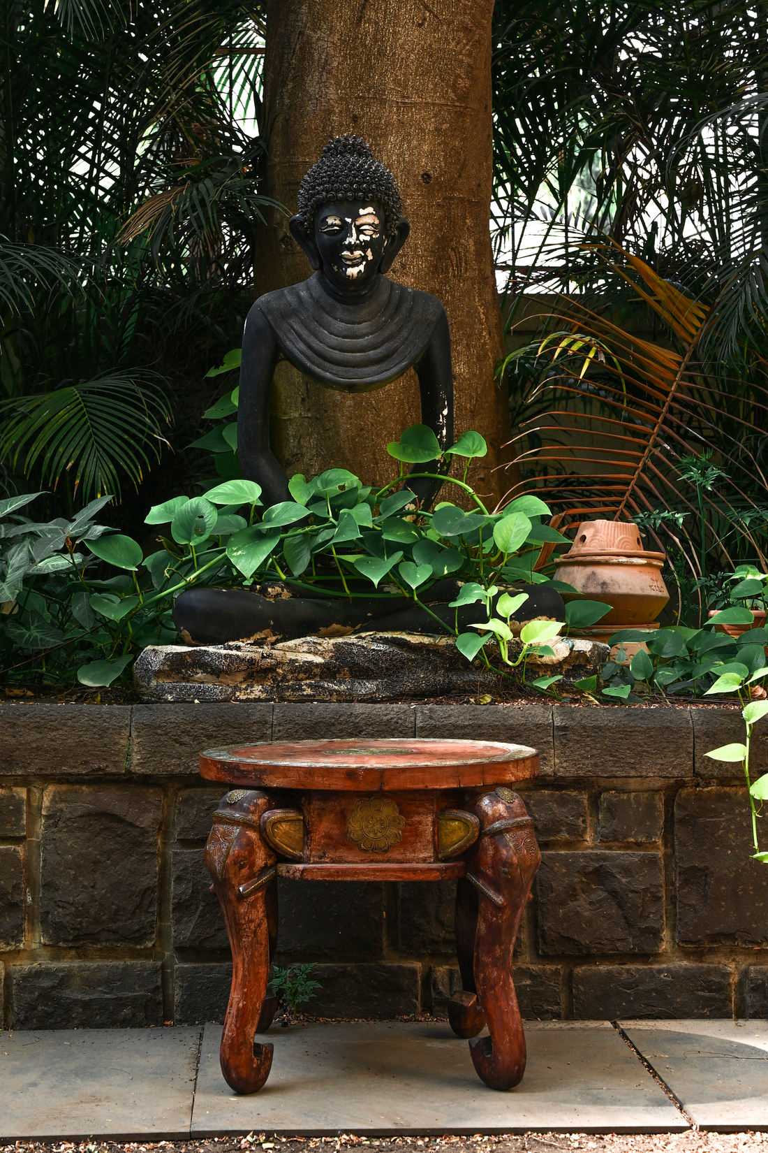 ELEPHANT MEDALLION - ROUND TEAK TABLE WITH BRASS REPOUSSÉ ELEPHANT FACES