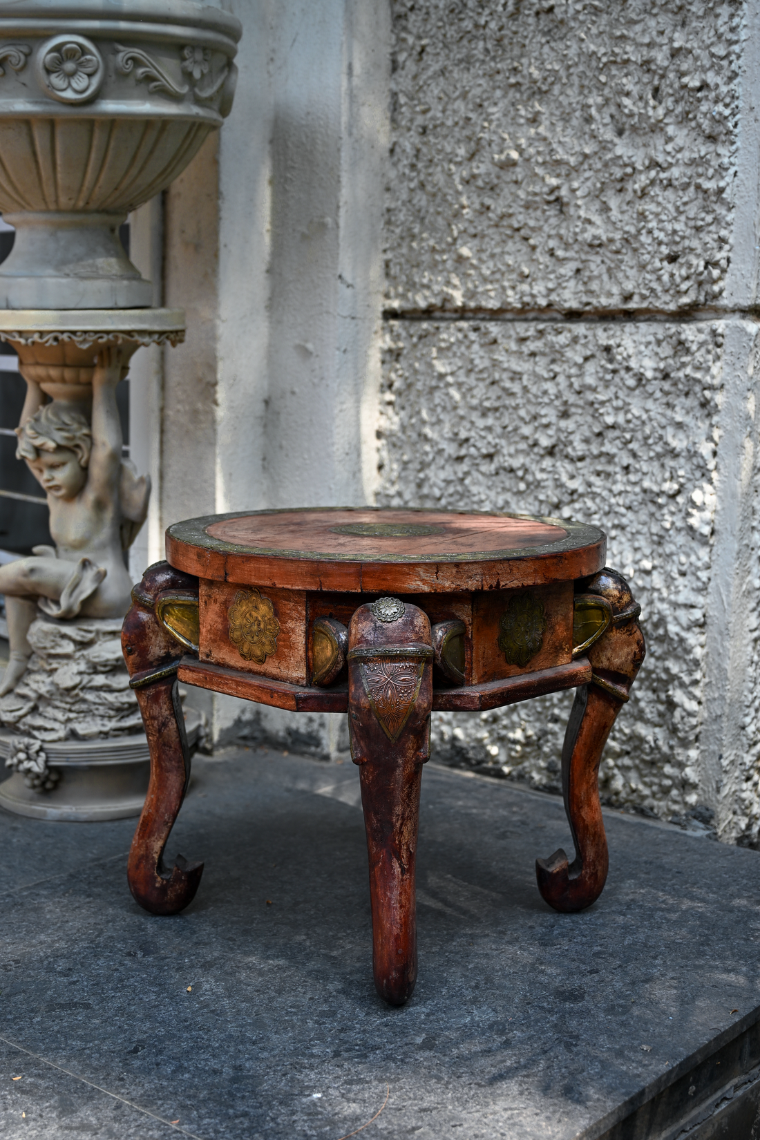 ELEPHANT MEDALLION - ROUND TEAK TABLE WITH BRASS REPOUSSÉ ELEPHANT FACES