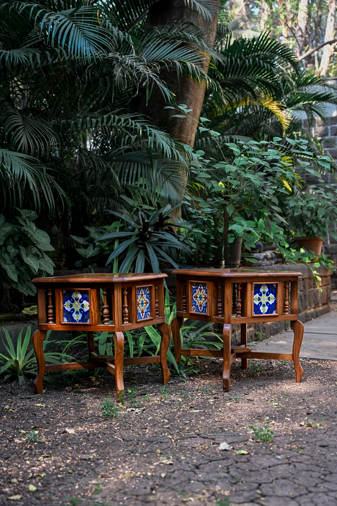 BOTANICAL SYMMETRY – PAIR OF TEAK SIDE TABLES WITH CERAMIC TILE INLAYS