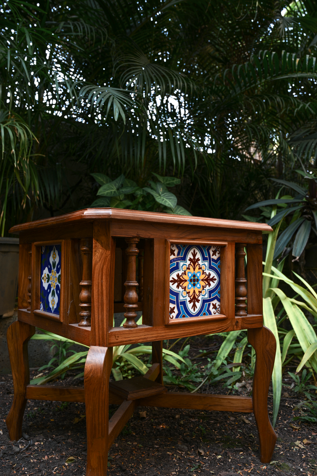 BOTANICAL SYMMETRY – PAIR OF TEAK SIDE TABLES WITH CERAMIC TILE INLAYS